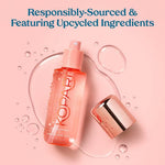 Kopari tropical peach hair and body mist bottle held in hand
