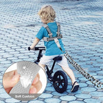 Child wearing Gloglow toddler backpack harness in a public park