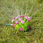 Durable and flexible toddler sprinkler base resting on green grass for outdoor play.