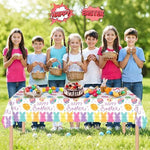 Litmitfu 108 by 54 inch rectangular Easter tablecloth set up as a festive backyard picnic backdrop
