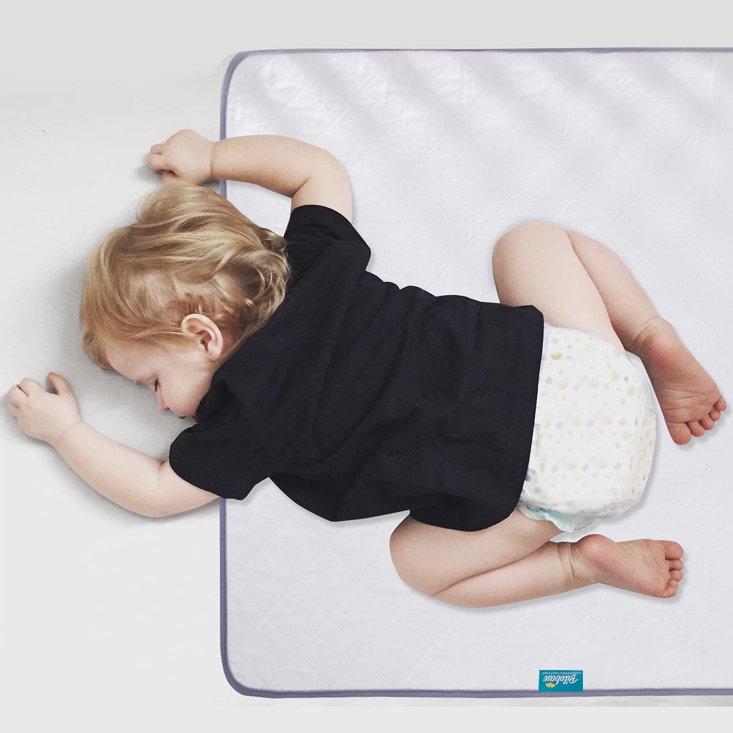 Biloban waterproof crib mattress protector front view showcasing the white quilted design