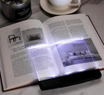 Generic LED book light placed on an open paperback book