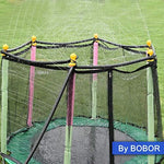 Full view of a circular trampoline transformed into an outdoor water spray park with mist nozzles operating.