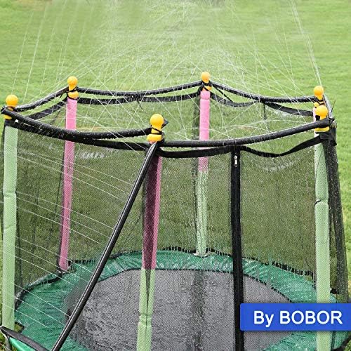 Full view of a circular trampoline transformed into an outdoor water spray park with mist nozzles operating.