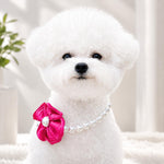 Adjustable faux pearl pet collar with a bright pink ribbon flower attachment