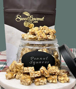 Close up view of gluten free sweet and salty peanut squares on a dessert table.