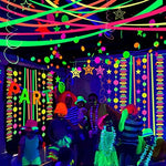 Creative ceiling canopy setup using twisted neon glow in the dark party decorations
