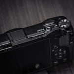 Iborrys thumb up grip for Ricoh GR IV camera front view showing premium black anodized finish.
