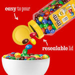 Two large twenty three ounce jars of peanut M&M's side by side on a clean kitchen counter