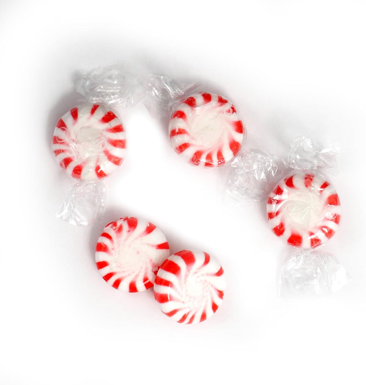 BoostBox Starlight Peppermint Mints being poured into a transparent glass office candy bowl.