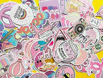 Wooowyet cute pink stickers being peeled cleanly off a laptop surface demonstrating residue free removal