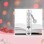 Stainless steel sobriety anniversary gift bookmark resting inside a book page