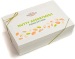 Six individually wrapped pieces of fresh artisan nutty fudge arranged inside the box