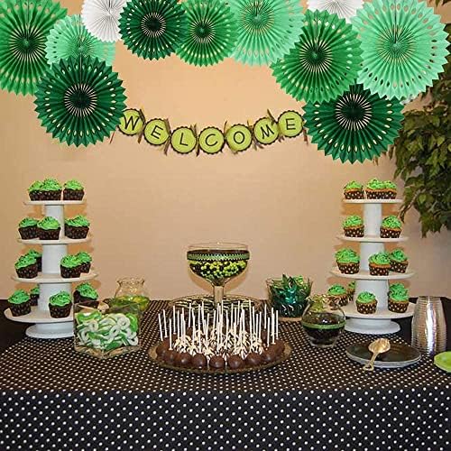 Vibrant birthday backdrop decoration featuring hanging round paper fans arranged nicely over a dessert table setup.