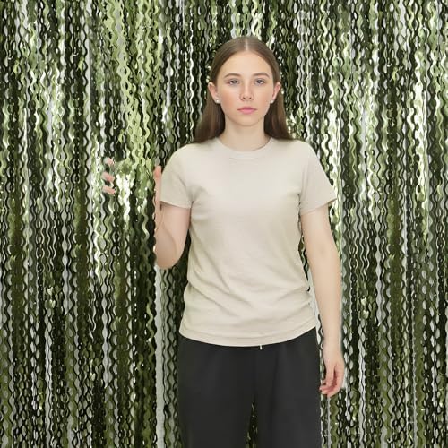 Peel and stick adhesive strip on the top of the green backdrop curtain.