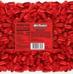 Close up view of red oblong chewy cinnamon candies from the bulk pack