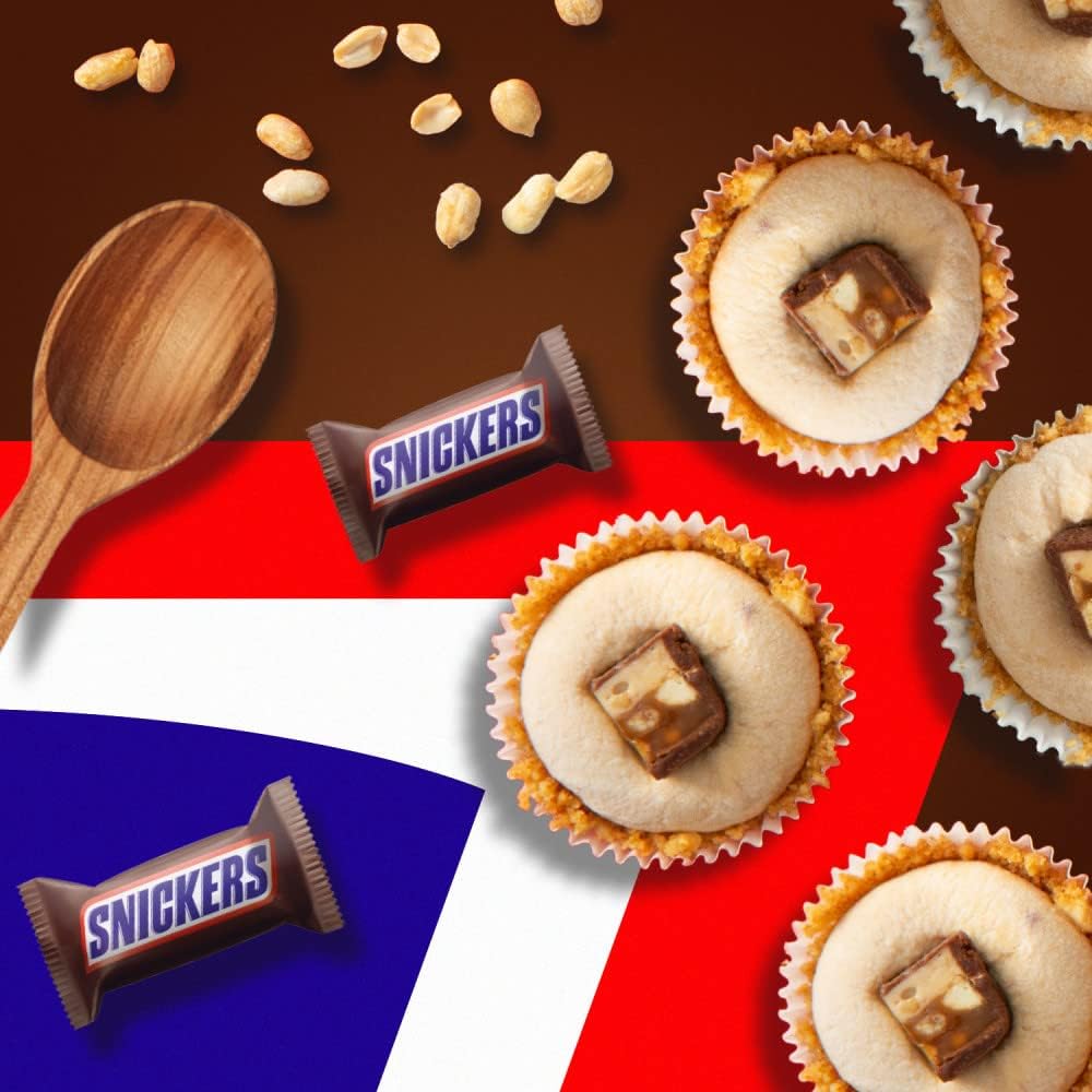 Multiple imported Snickers chocolate share bags arranged neatly together, illustrating stock availability for bulk sweet cravings.