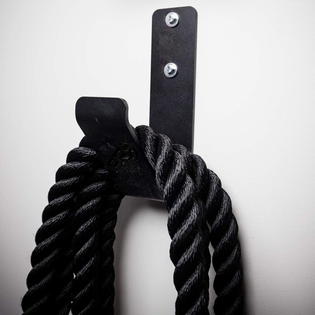 Wall mounted battle rope holder installed on a gym wall
