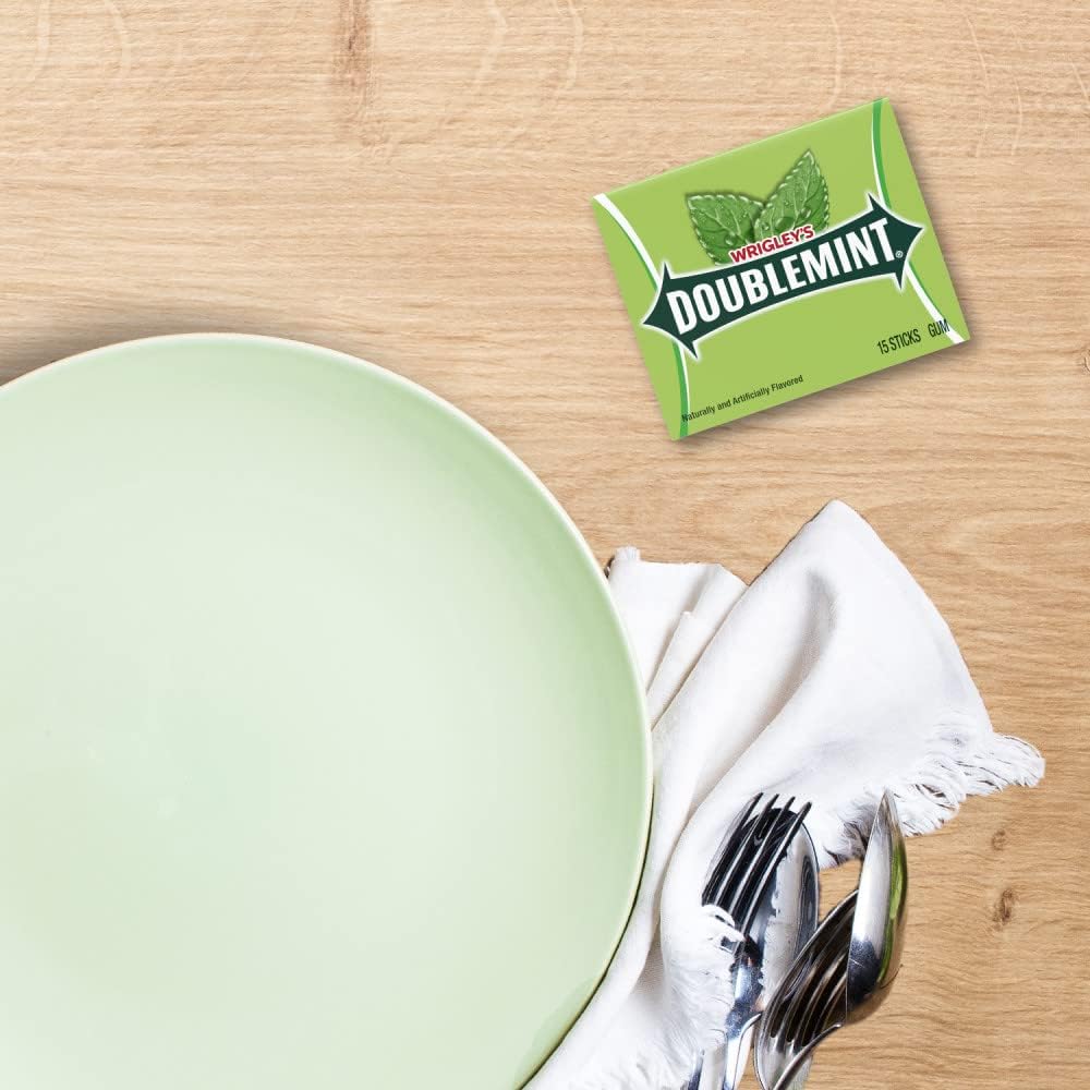 Triple pack of Wrigley's Doublemint sweet mint chewing gum showing the fifteen count quantity.