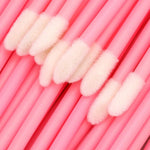 Pink lip gloss brushes arranged for cosmetic storage