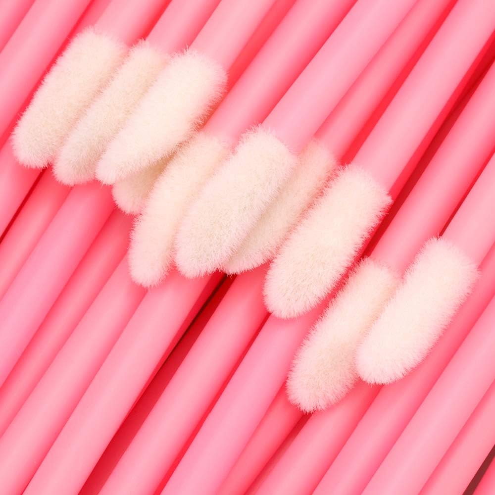 Pink lip gloss brushes arranged for cosmetic storage