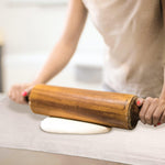 Freshly baked artisan bread resting on linen couche