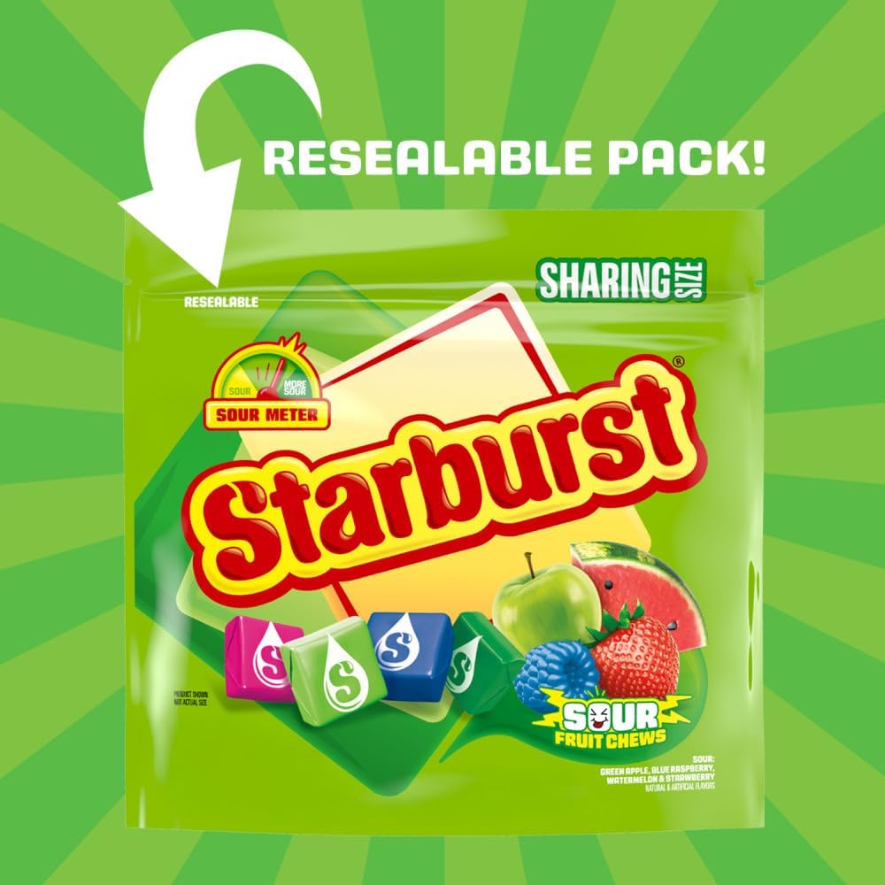 Hand holding an individually wrapped Starburst Sour strawberry flavored chewy candy
