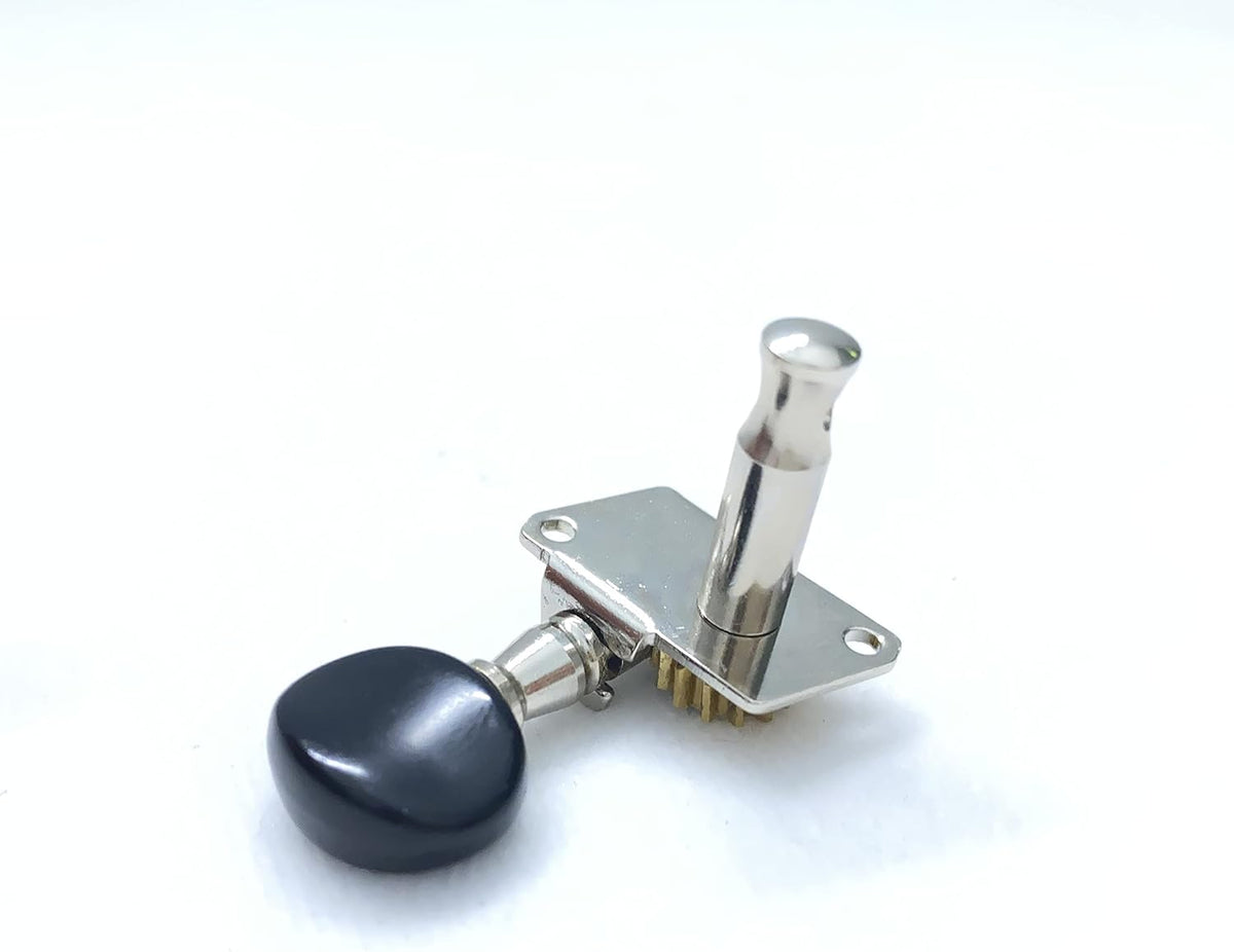 Close up of black plastic buttons on tuning pegs