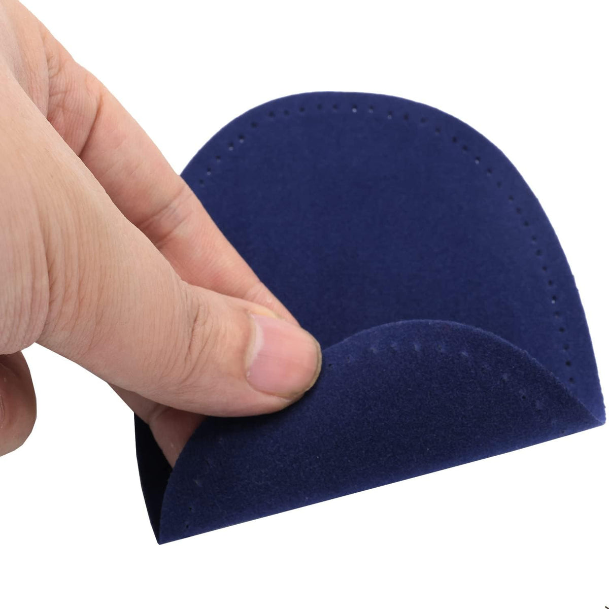 Blue suede repair appliques laid flat for sweater and trouser mending