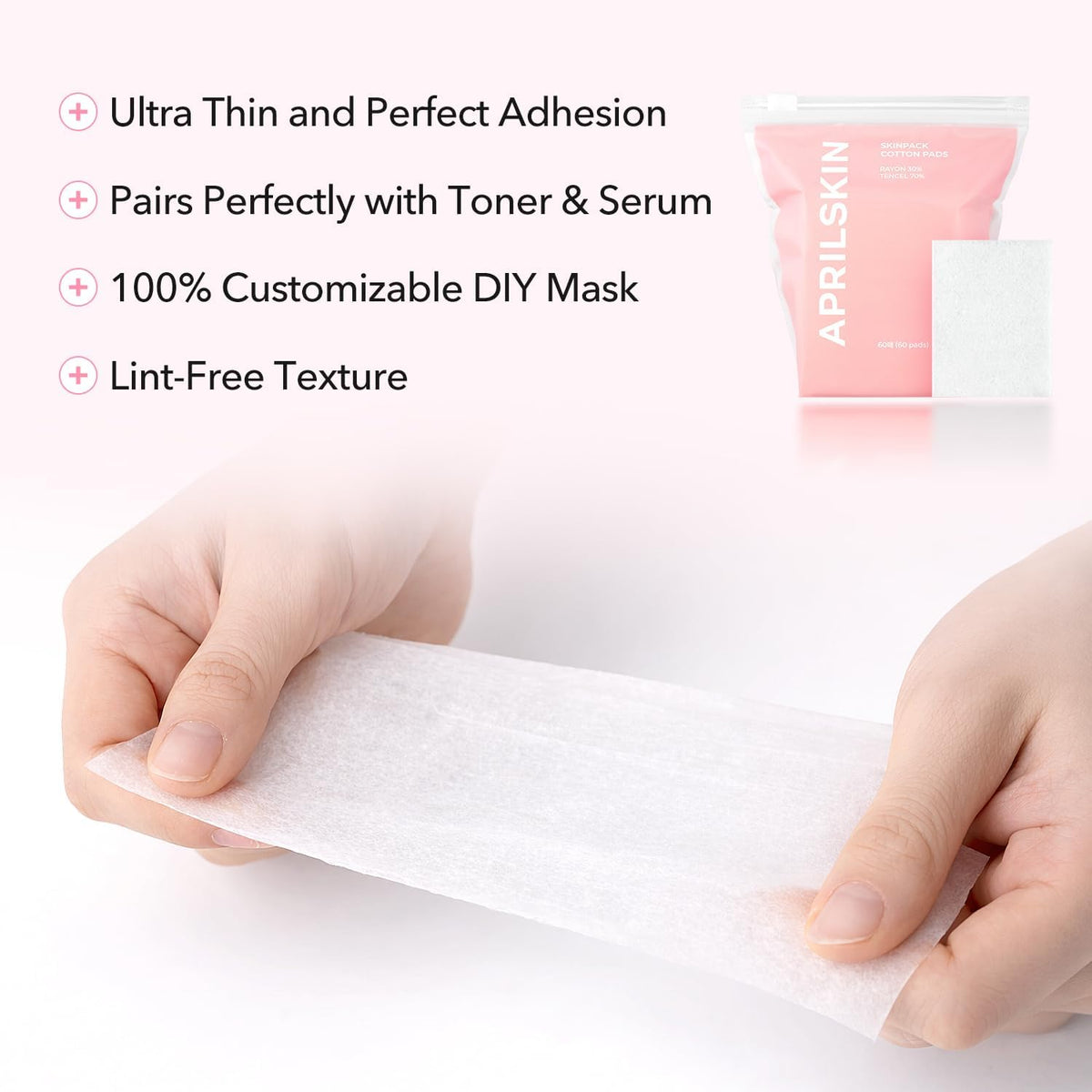 Close up of a single lint free Tencel blend facial pad being stretched for a custom face fit.
