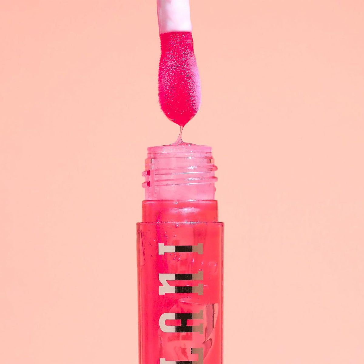 Milani vegan Vitamin E lip gloss swatches on skin