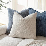 Set of two Foindtower decorative plush boucle cushion cases displayed together on an elegant accent chair
