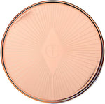 Model applying Charlotte Tilbury Lip And Cheek Glow to cheeks