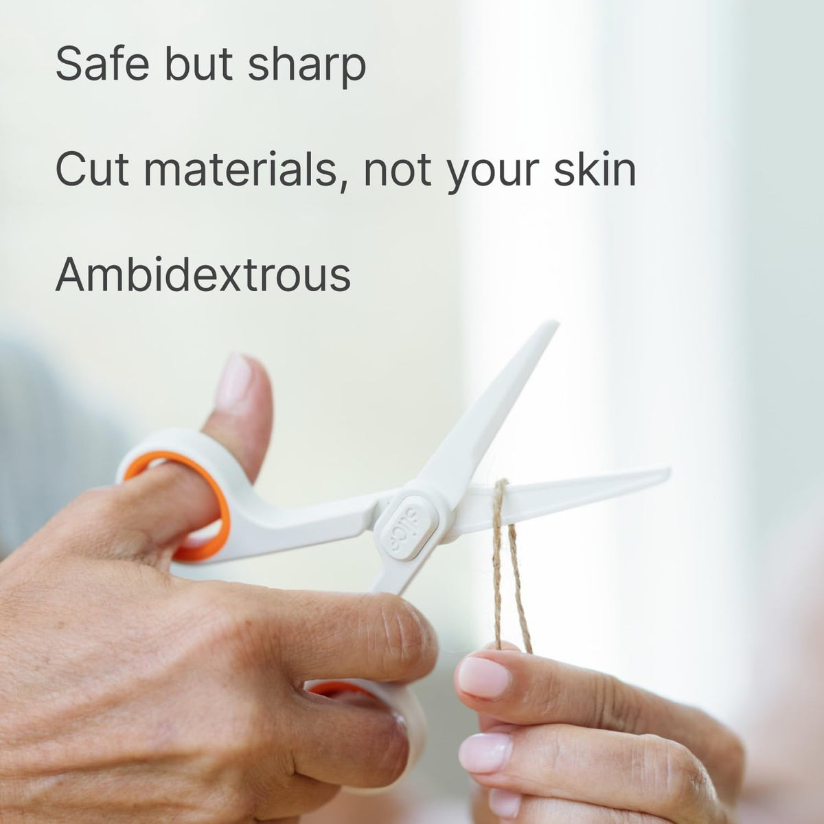 Slice safety scissors showing white ceramic blade close-up