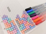 Sakura medium point black pens lifestyle flat lay