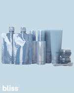 Bliss denim blue travel toiletries set being filled with shampoo and conditioner.
