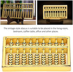 Handheld brass abacus showing metallic luster
