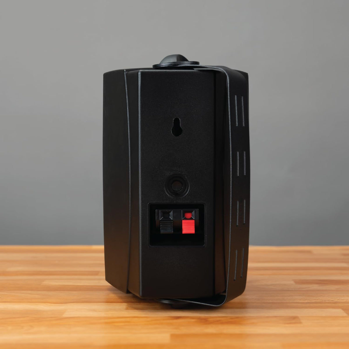 Dual Electronics LU43PB speakers installed on a covered patio wall