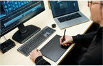 Wacom digital art pad showing top mechanical dials and shortcuts for creative software.