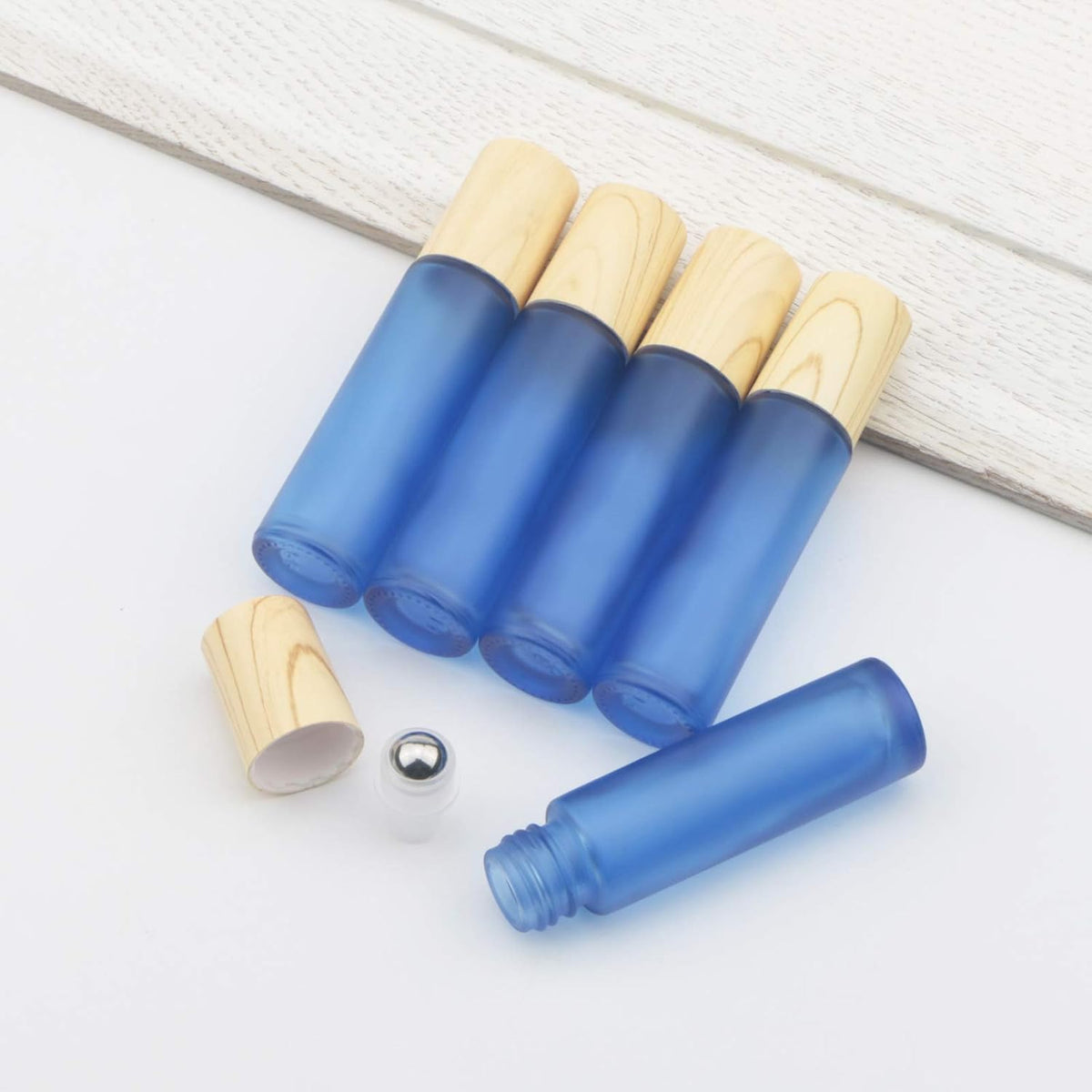 Kesell roll on bottles displayed with bottle opening tool