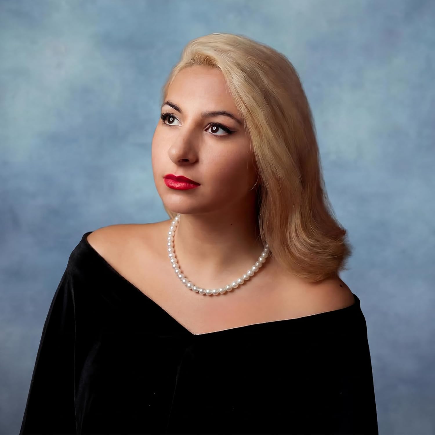Cunno senior black velour drape for photography front view with pearl necklace.