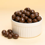 Whole roasted espresso coffee beans with smooth milk chocolate glaze