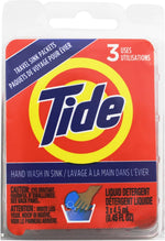 Tide travel sink wash packets shown beside travel luggage