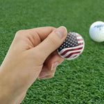 Close up of chrome plated metal golf ball marker with waving stars and stripes design