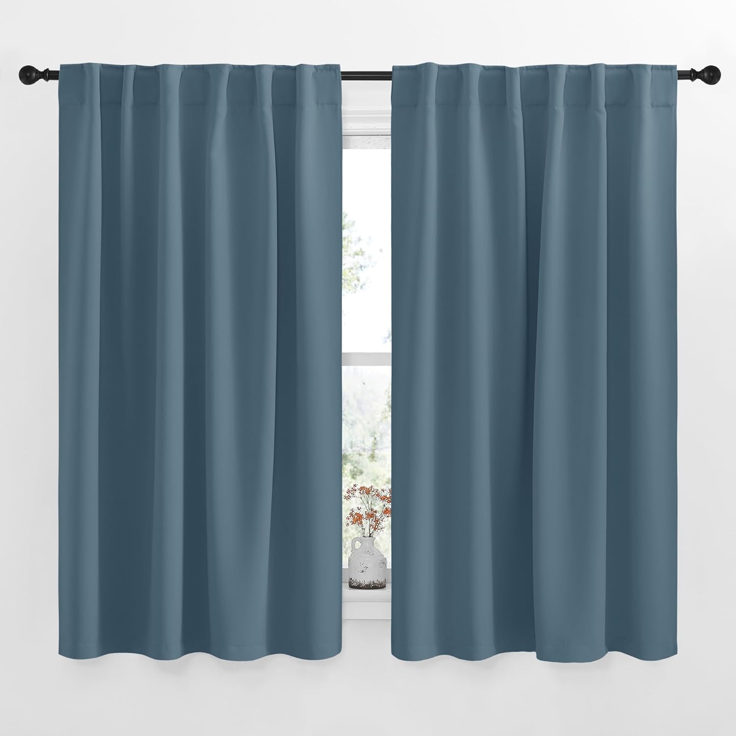 NICETOWN Blackout Curtains Smoky Blue front view hanging in a bright nursery window.