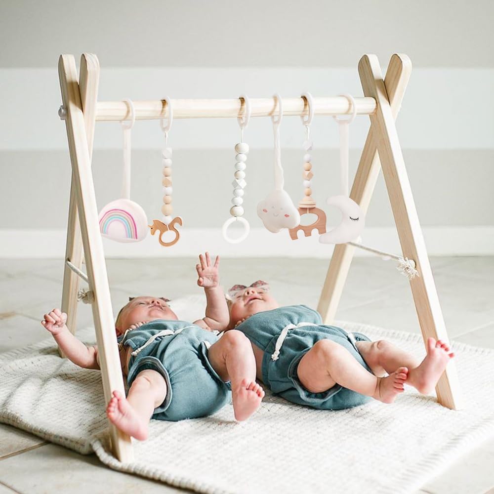 Mallify wooden baby gym front view showcasing the natural pine wood foldable frame and six hanging sensory toys.