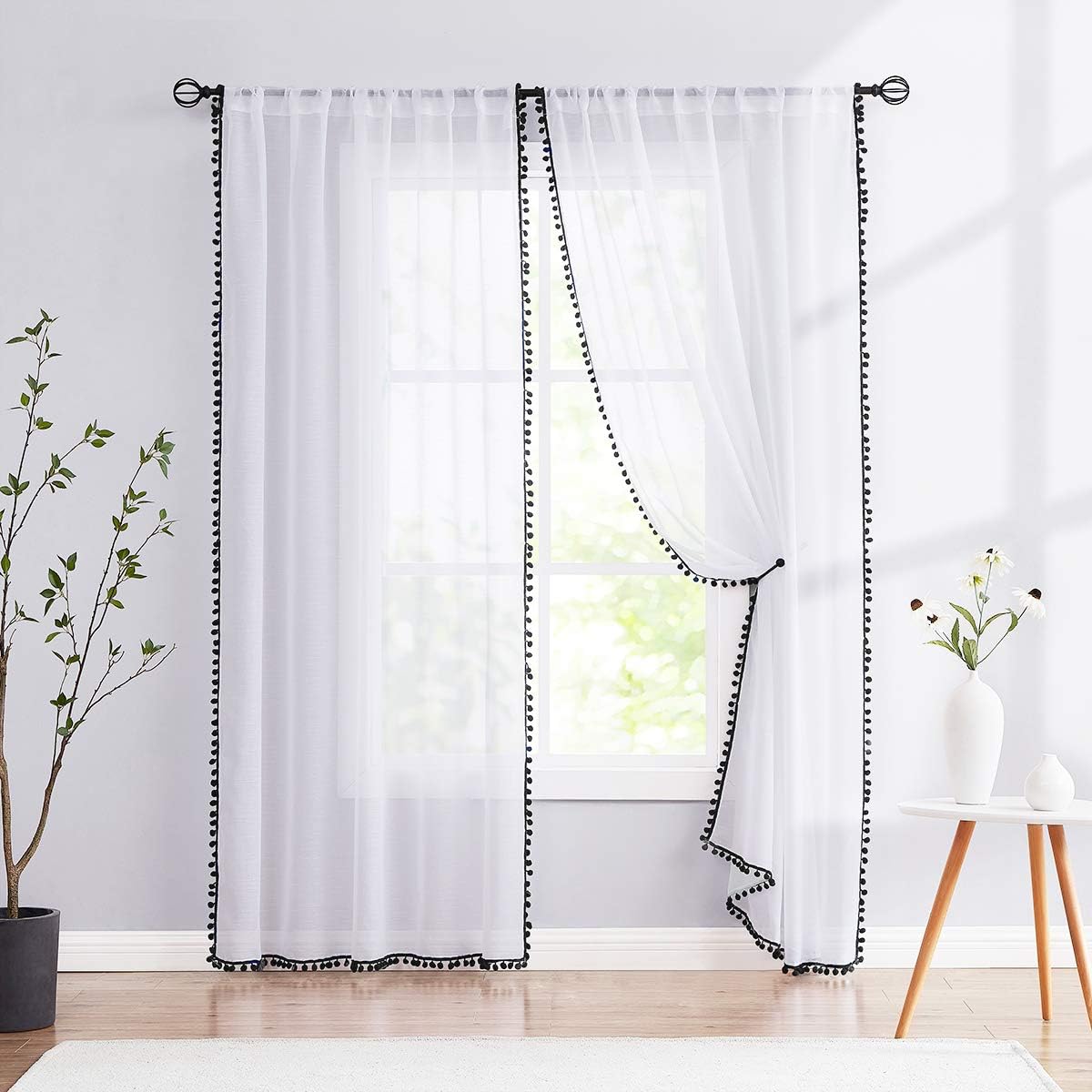 Treatmentex black and white sheer curtains front view showing linen texture fabric draperies hanging in a bright living room window