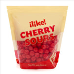 Vibrant red sour candy cherry balls poured out of a bulk two-pound pack