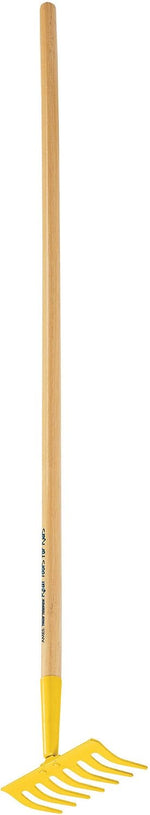 Young gardener holding the downsized garden tool outdoors