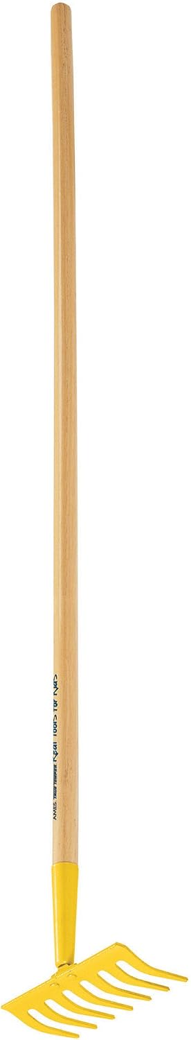 Young gardener holding the downsized garden tool outdoors